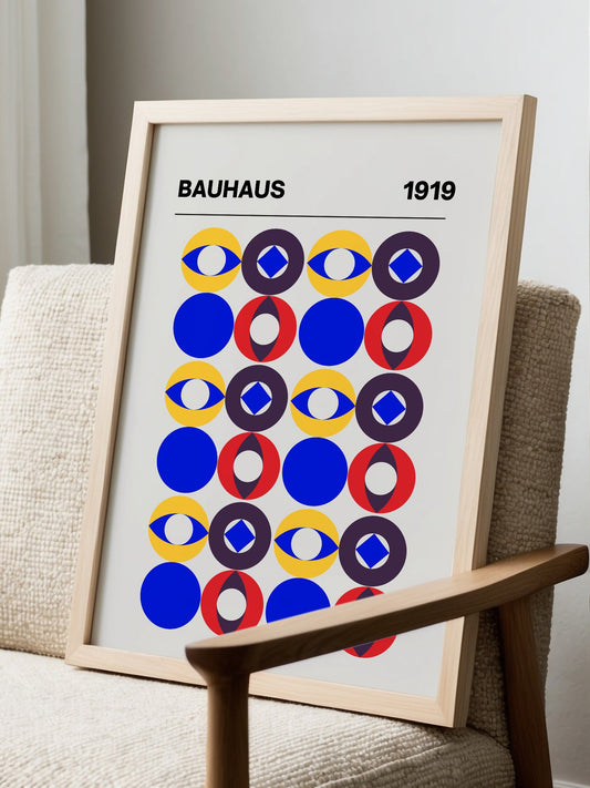 Bauhaus 1919 poster with geometric grid of colourful circles featuring eyes, displayed in modern living room setting