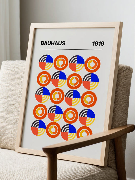 Bauhaus 1919 geometric wall art print with repeating orange blue and yellow, displayed in modern living room setting