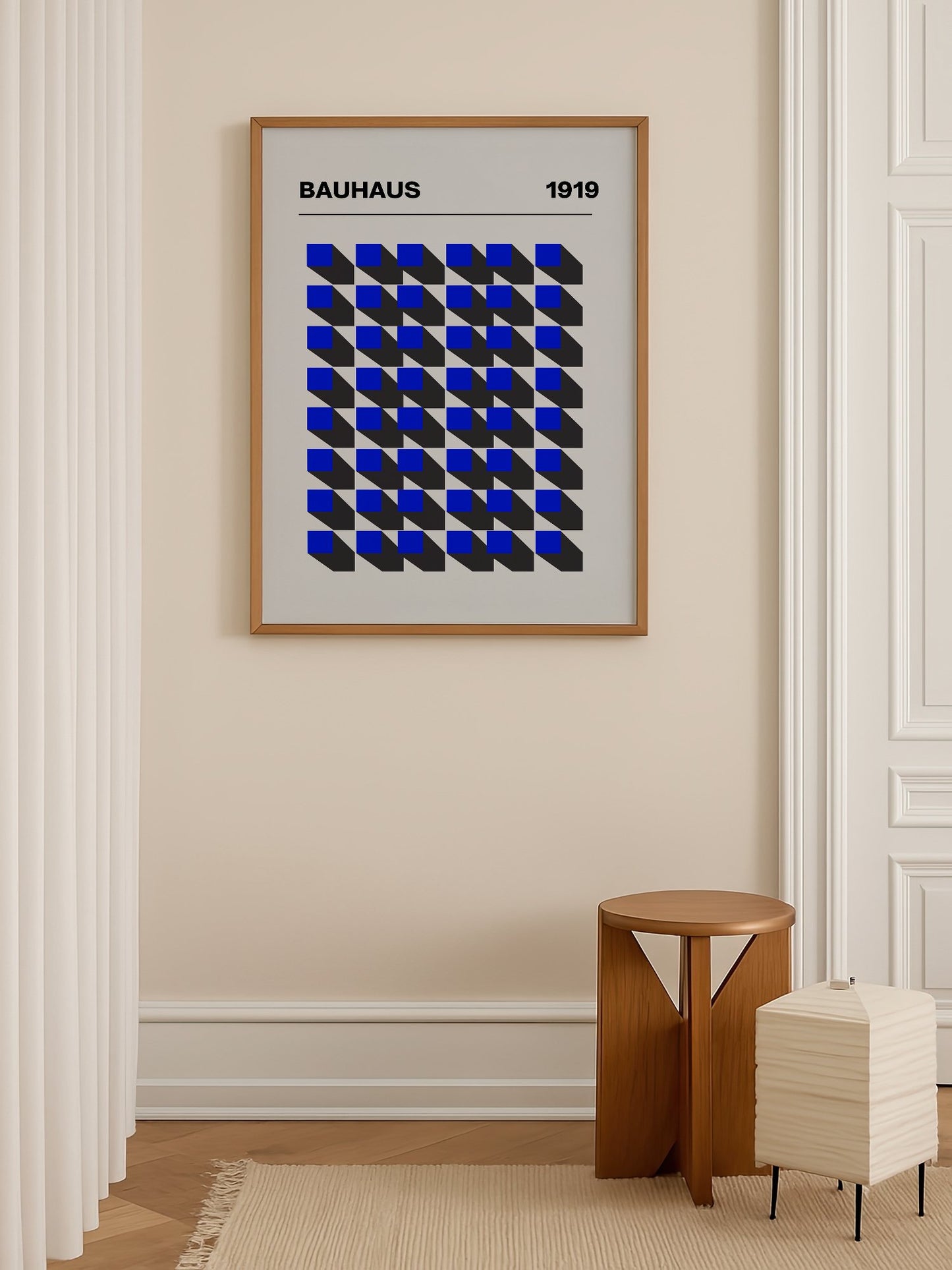 Bauhaus 1919 geometric poster featuring blue isometric cubes arranged in grid, shown in minimalist home office space