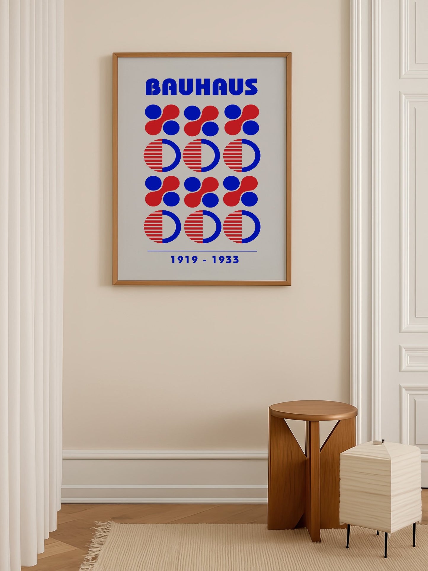 Bauhaus geometric poster featuring blue and red circles and semicircles in grid, shown in minimalist home office space