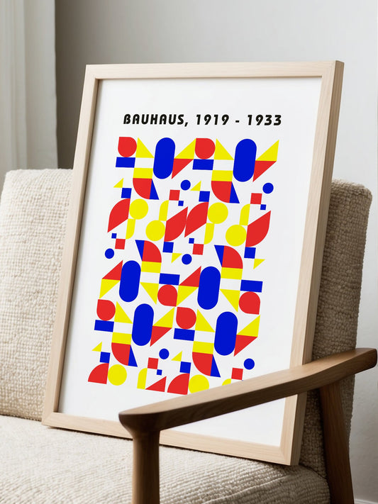 Bauhaus geometric poster with red circles, yellow triangles, and blue ovals in, displayed in modern living room setting