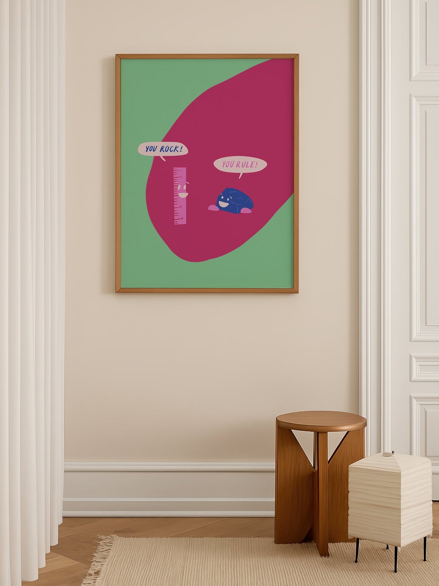Cartoon ruler and rock character poster with 'You Rock!' and 'You Rule!' speech, shown in minimalist home office space