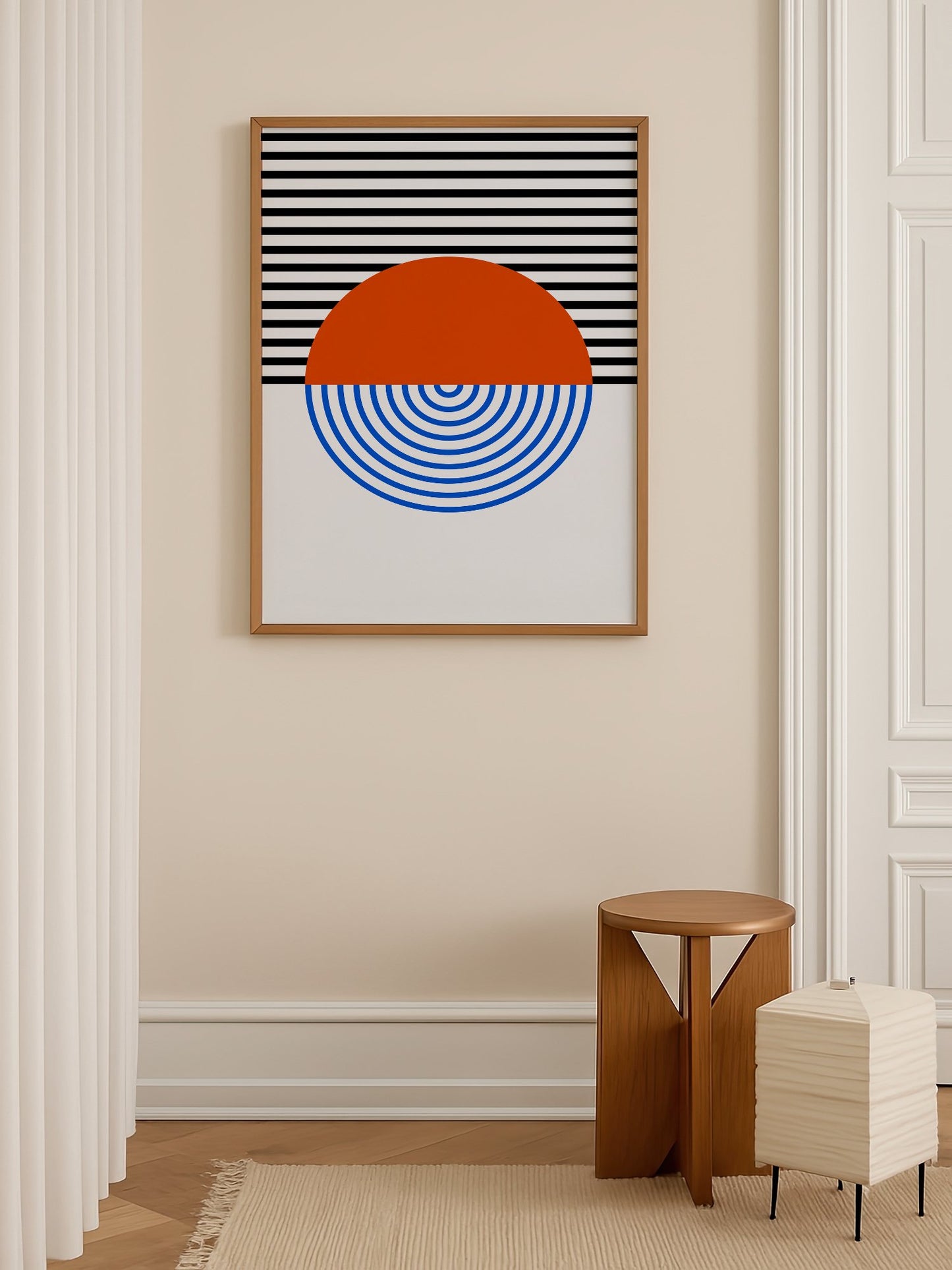 Geometric abstract wall art featuring split circle with orange top and blue, shown in minimalist home office space