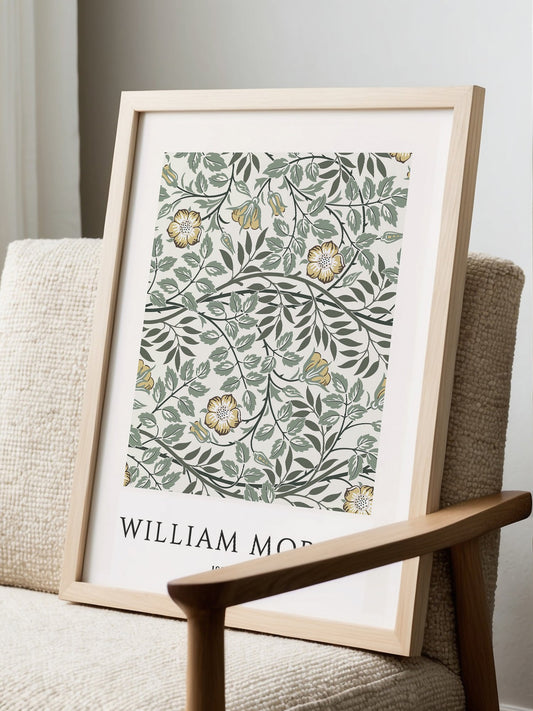 Vintage botanical wall art print featuring floral vines and leaves in green and, displayed in modern living room setting