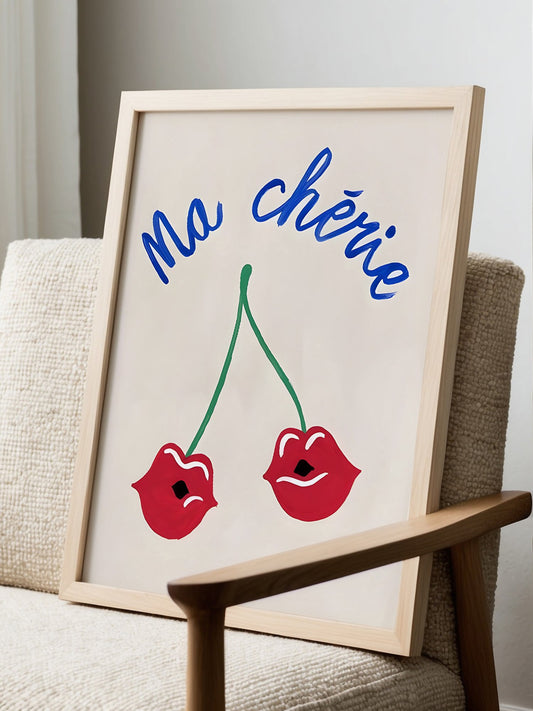 Playful cherry lips art print with blue 'Ma Chérie' text, romantic wall decor, displayed in modern living room setting