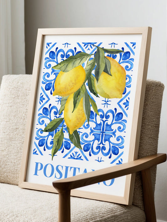 Positano lemon watercolor art print with yellow citrus fruit on Italian blue, displayed in modern living room setting