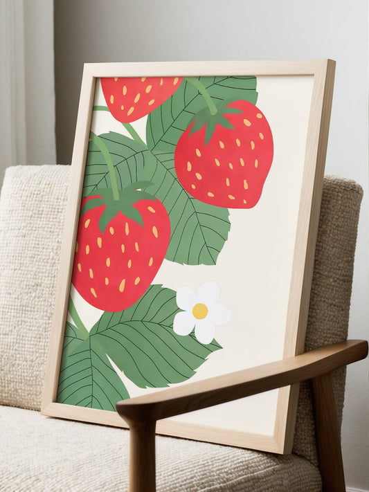 Botanical wall art print featuring three coral-red strawberries with green, displayed in modern living room setting