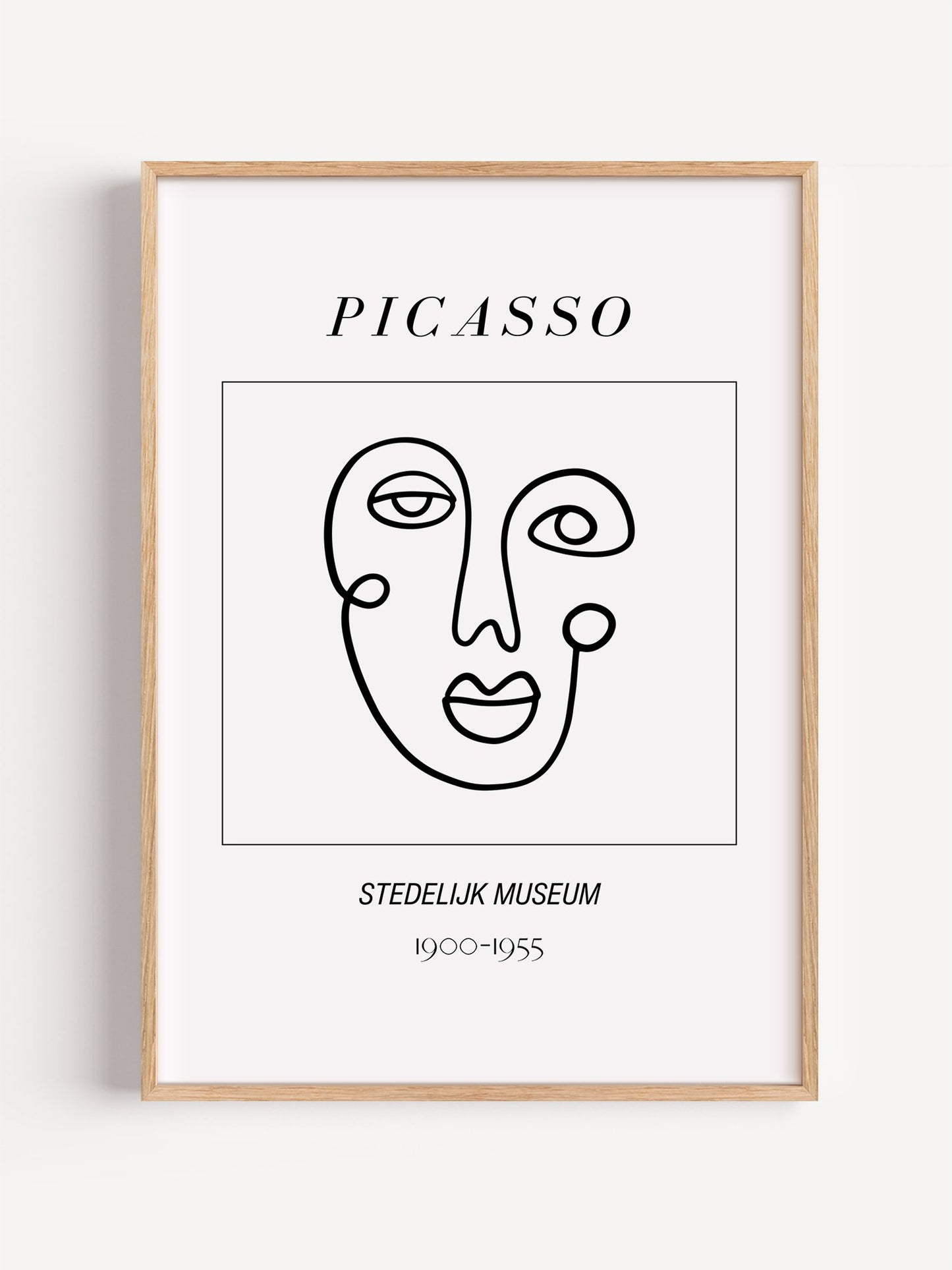 Abstract Picasso face art print featuring minimalist black line drawing on, close-up showing print texture and color detail