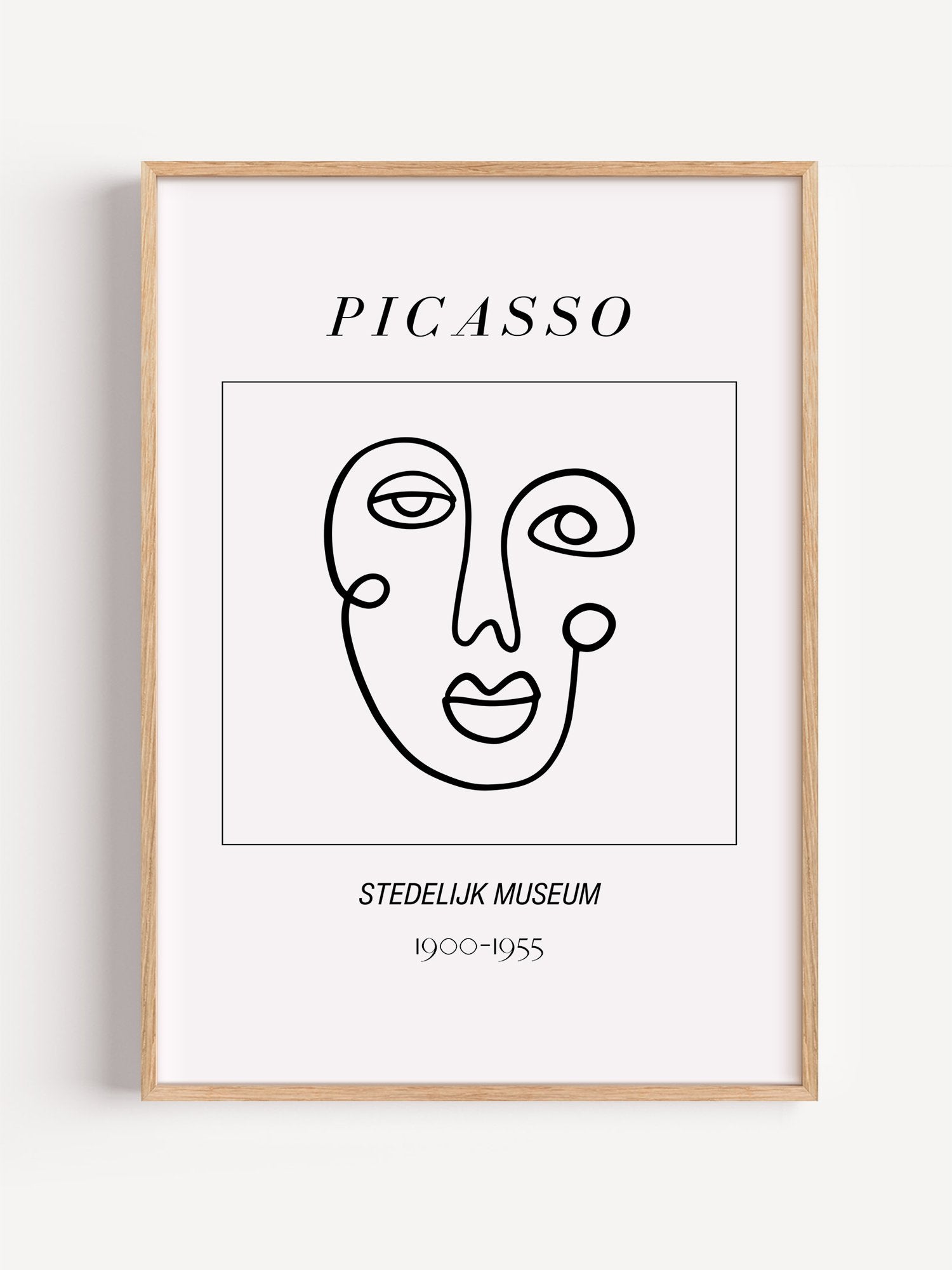 Abstract Picasso face art print featuring minimalist black line drawing on, close-up showing print texture and color detail
