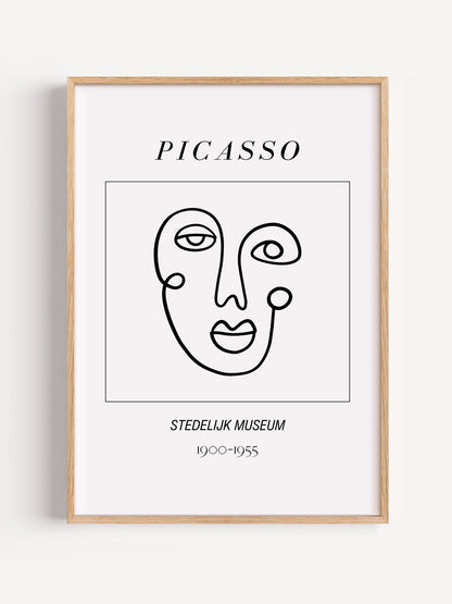 Abstract Picasso face art print featuring minimalist black line drawing on, close-up showing print texture and color detail