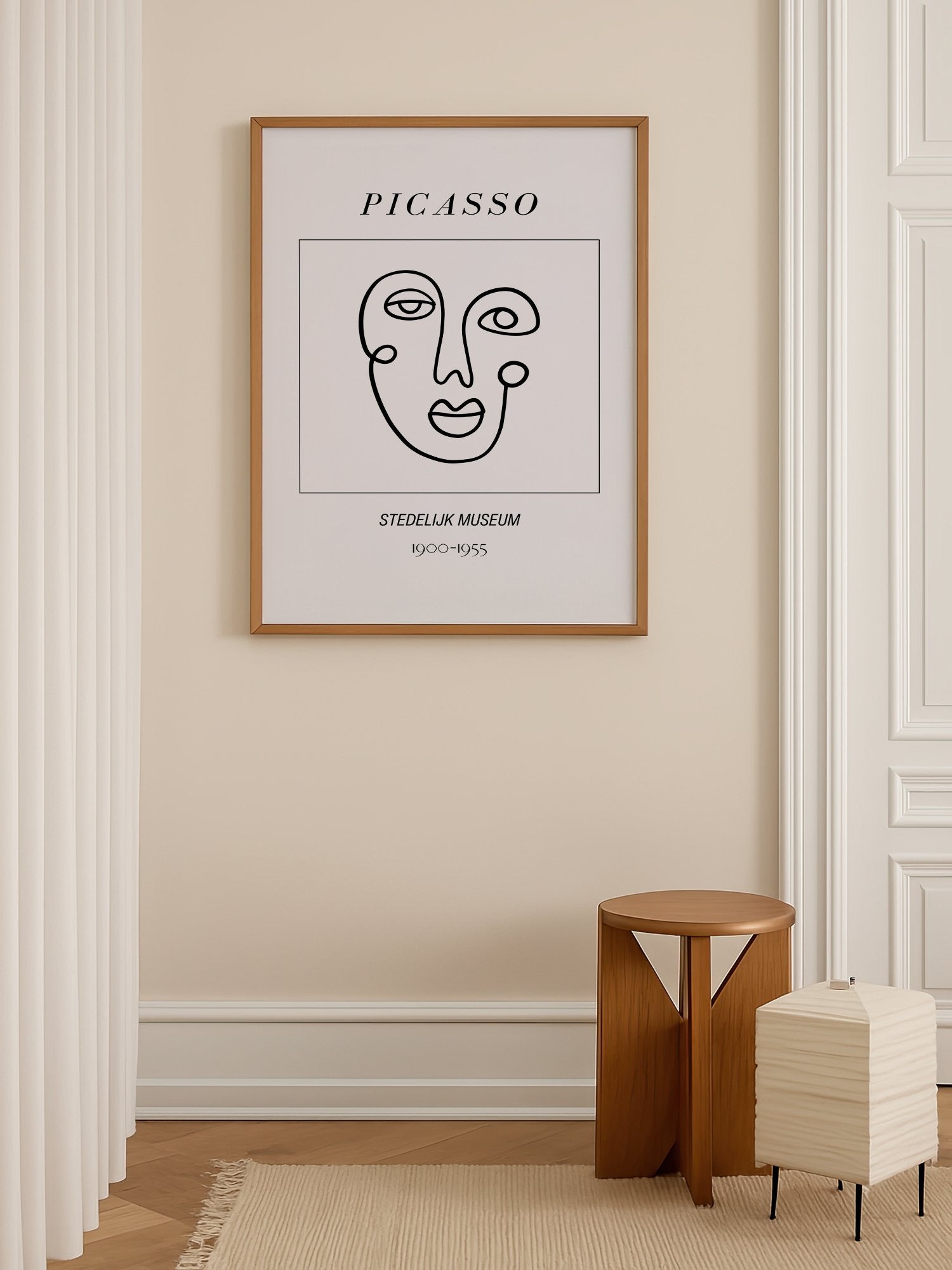Abstract Picasso face art print featuring minimalist black line drawing on, shown in minimalist home office space