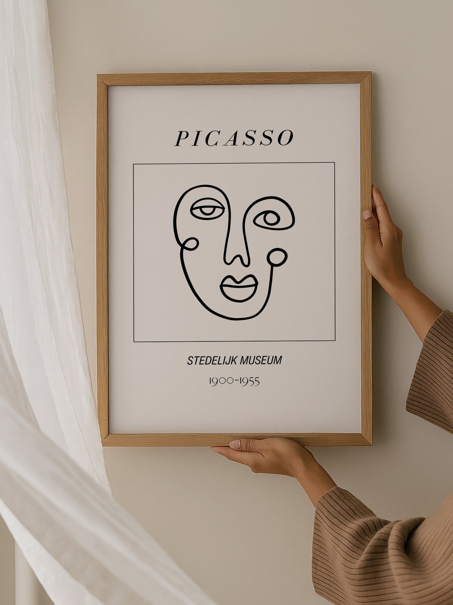 Abstract Picasso face art print featuring minimalist black line drawing on, hanging in contemporary bedroom interior