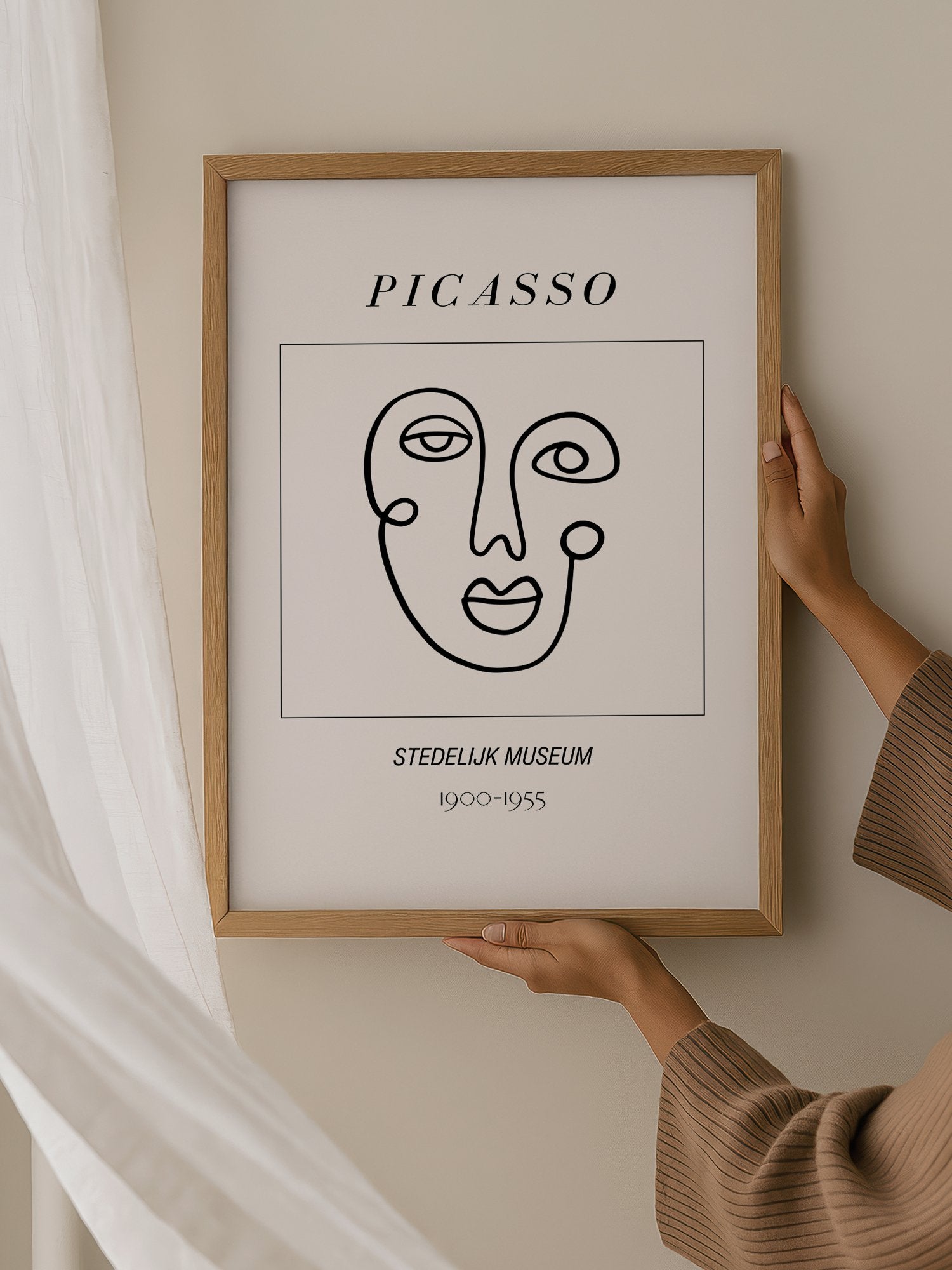 Abstract Picasso face art print featuring minimalist black line drawing on, hanging in contemporary bedroom interior