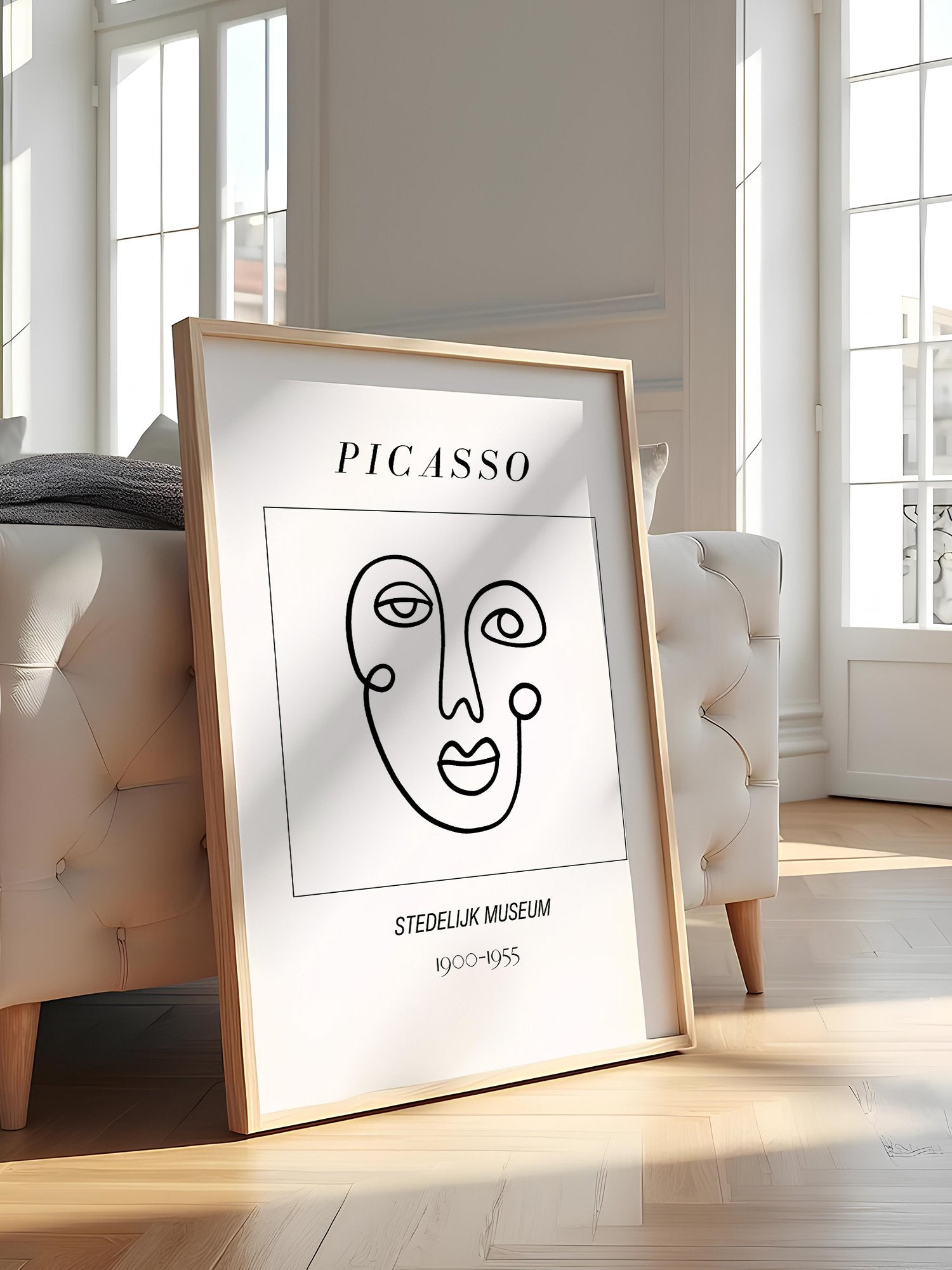 Abstract Picasso face art print featuring minimalist black line drawing on, featured in stylish apartment decor