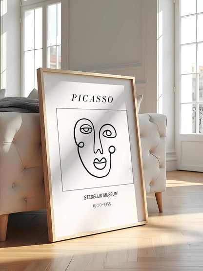 Abstract Picasso face art print featuring minimalist black line drawing on, featured in stylish apartment decor
