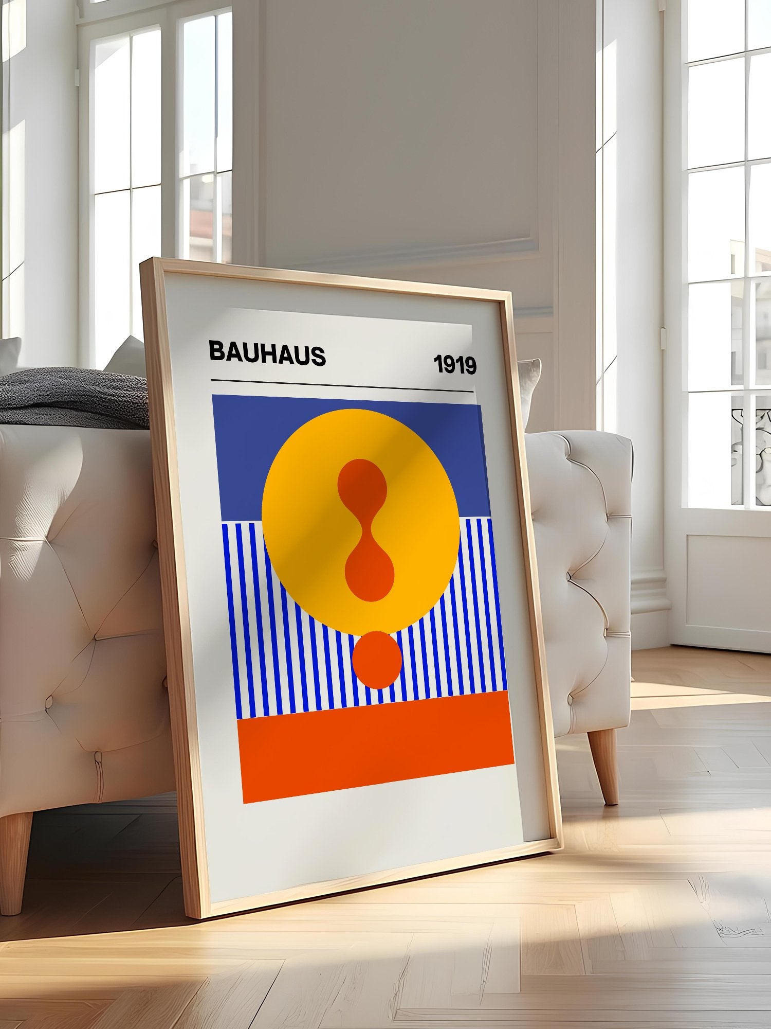 Bauhaus 1919 geometric poster featuring yellow circle with red hourglass shape, featured in stylish apartment decor