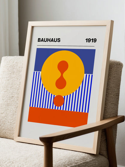 Bauhaus 1919 geometric poster featuring yellow circle with red hourglass shape, displayed in modern living room setting
