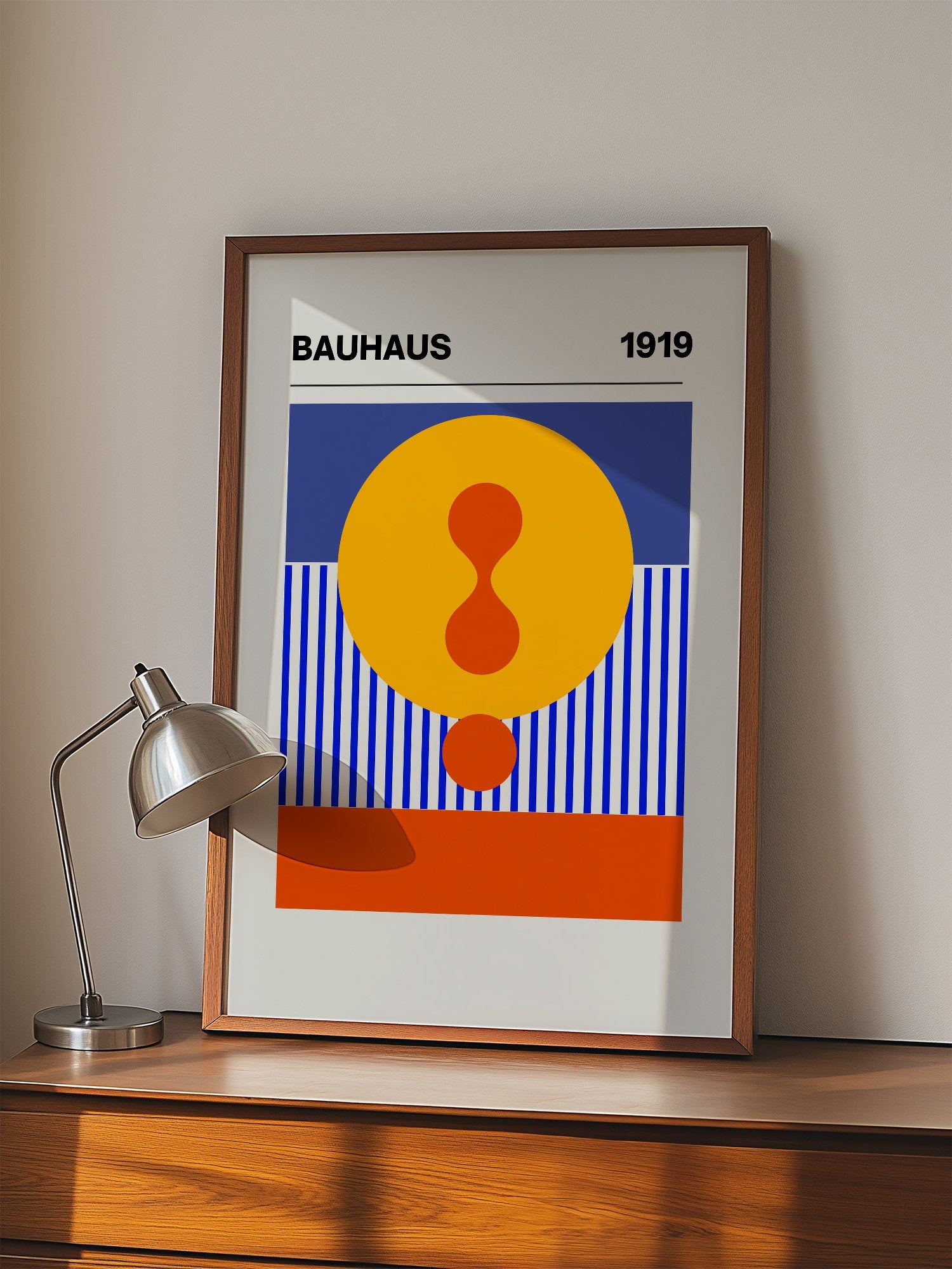 Bauhaus 1919 geometric poster featuring yellow circle with red hourglass shape, displayed in modern living room setting