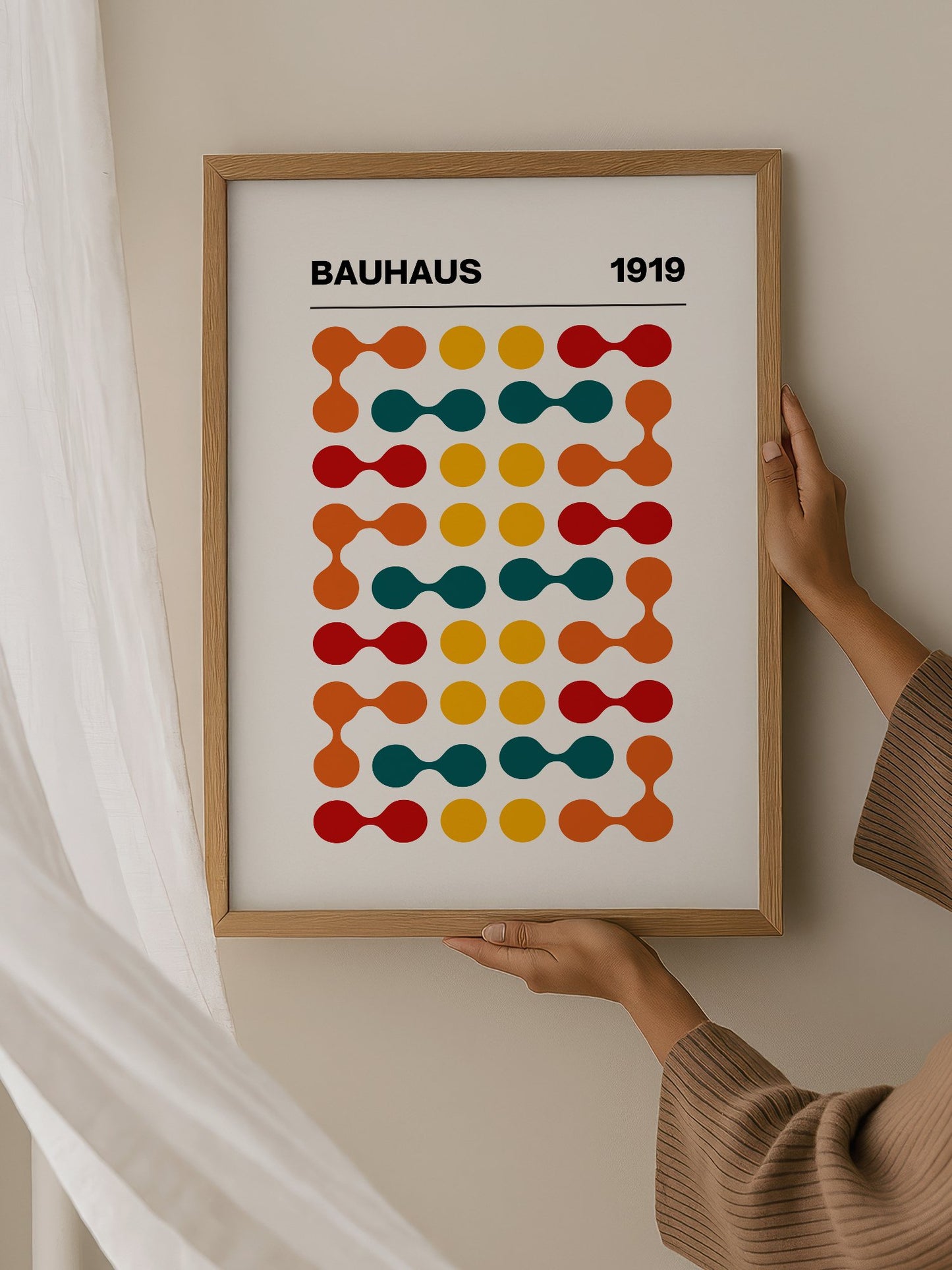 Bauhaus 1919 geometric wall art print featuring orange teal yellow and red, hanging in contemporary bedroom interior