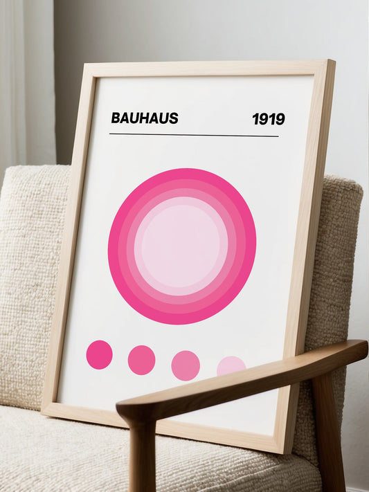Bauhaus 1919 poster with concentric pink circles in gradient shades on white, displayed in modern living room setting