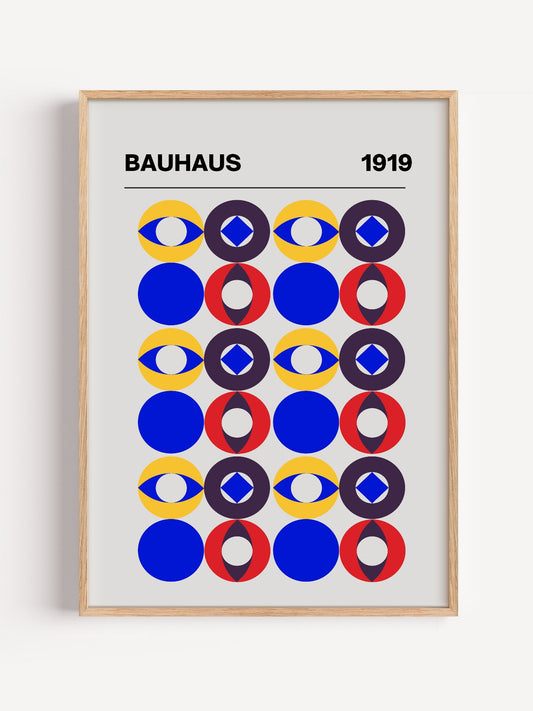 Bauhaus 1919 poster with geometric grid of colourful circles featuring eyes, close-up showing print texture and color detail