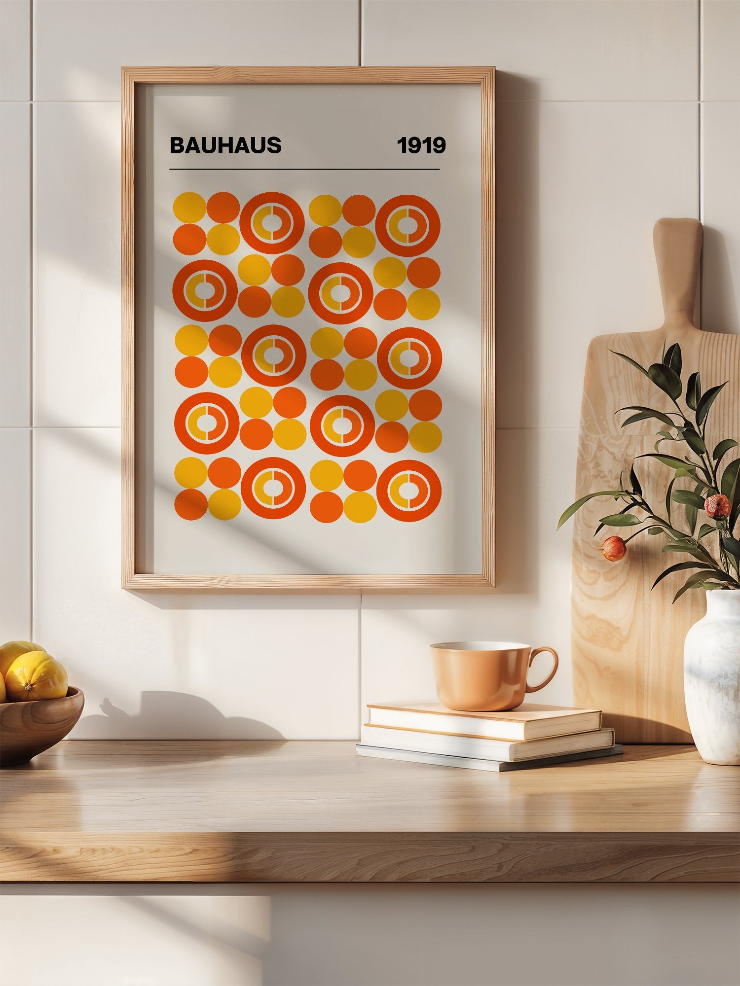 Bauhaus 1919 geometric poster featuring grid of orange and yellow concentric, hanging in contemporary bedroom interior