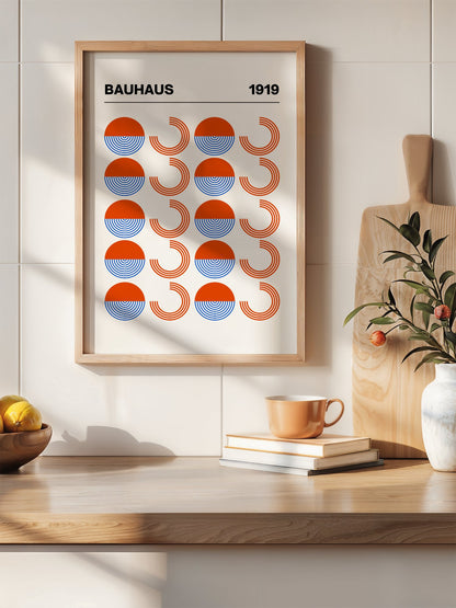 Bauhaus 1919 geometric poster featuring grid pattern of orange and blue, hanging in contemporary bedroom interior