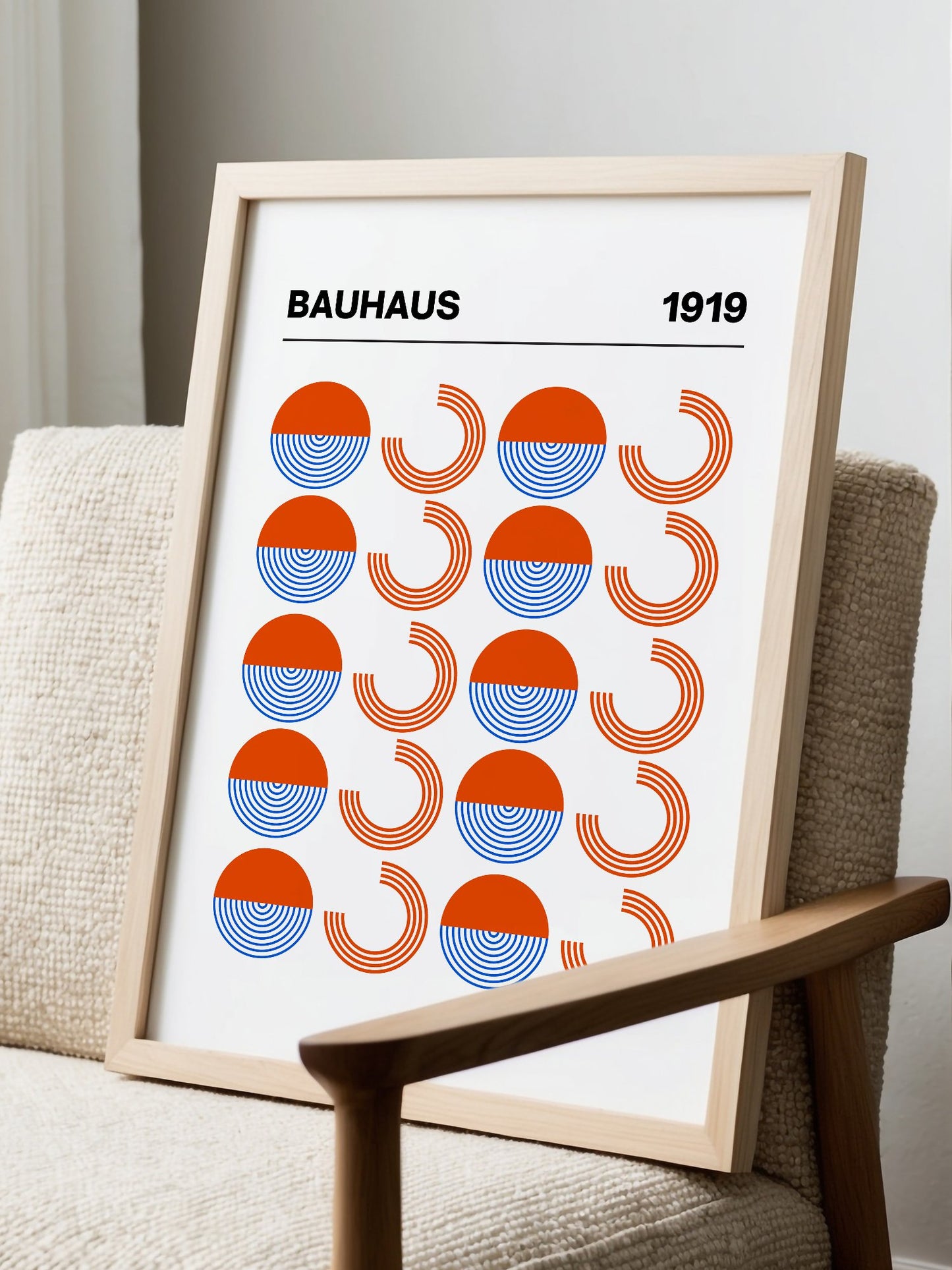 Bauhaus 1919 geometric poster featuring grid pattern of orange and blue, displayed in modern living room setting