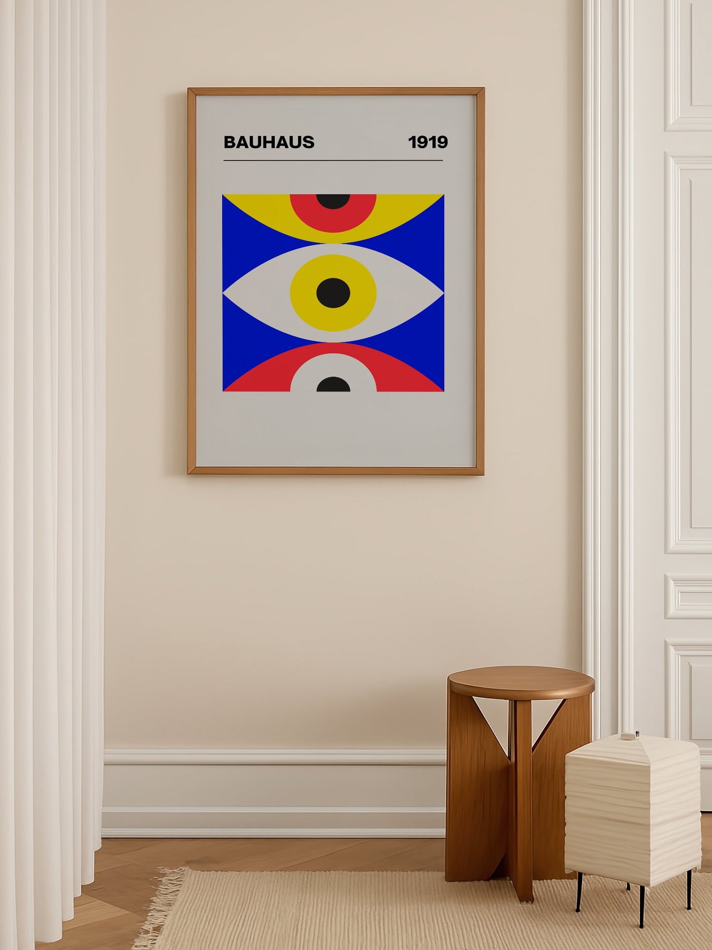 Bauhaus 1919 geometric poster with three stacked eye shapes in yellow red and, shown in minimalist home office space