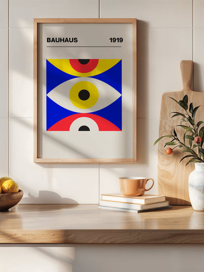 Bauhaus 1919 geometric poster with three stacked eye shapes in yellow red and, hanging in contemporary bedroom interior