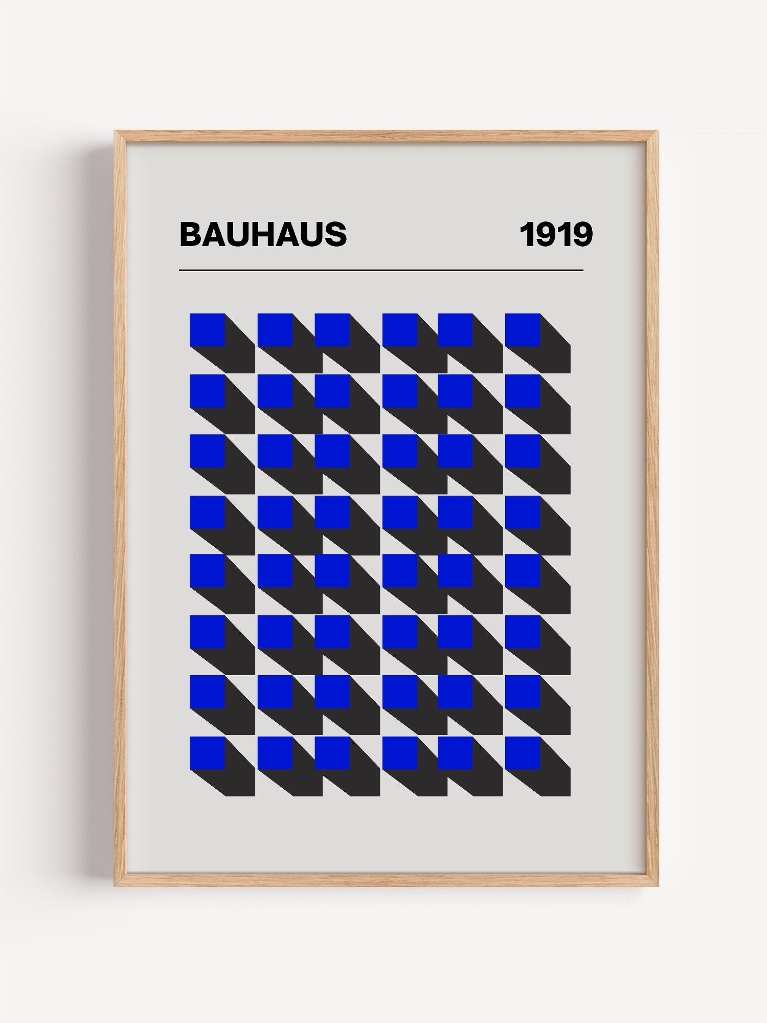 Bauhaus 1919 geometric poster featuring blue isometric cubes arranged in grid, close-up showing print texture and color de...