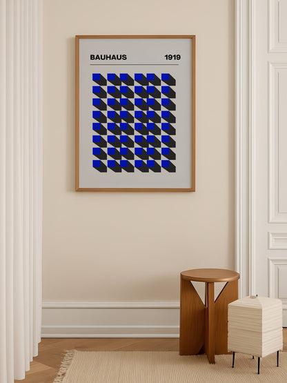 Bauhaus 1919 geometric poster featuring blue isometric cubes arranged in grid, shown in minimalist home office space