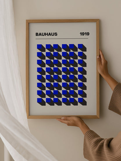 Bauhaus 1919 geometric poster featuring blue isometric cubes arranged in grid, hanging in contemporary bedroom interior