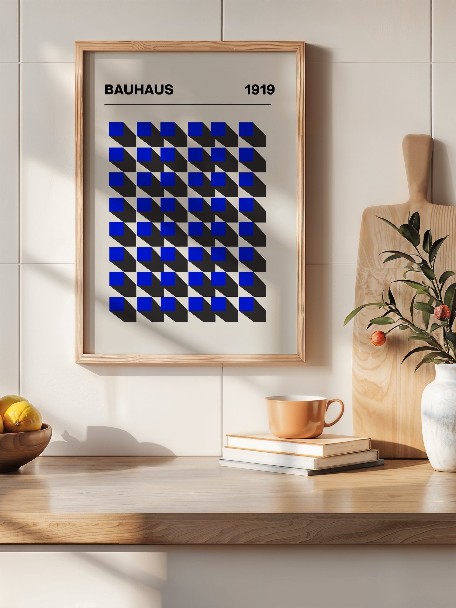 Bauhaus 1919 geometric poster featuring blue isometric cubes arranged in grid, hanging in contemporary bedroom interior