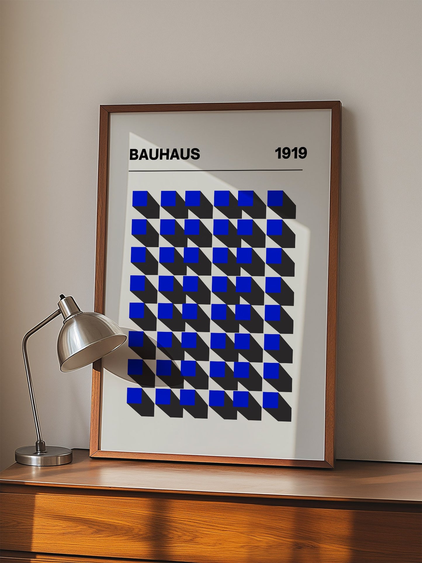 Bauhaus 1919 geometric poster featuring blue isometric cubes arranged in grid, displayed in modern living room setting
