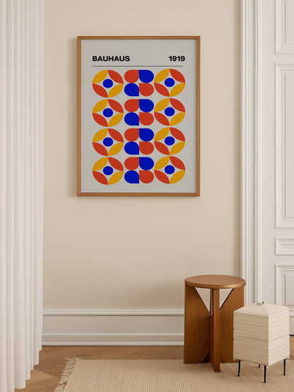 Bauhaus 1919 geometric poster featuring circular medallions in blue red yellow, shown in minimalist home office space