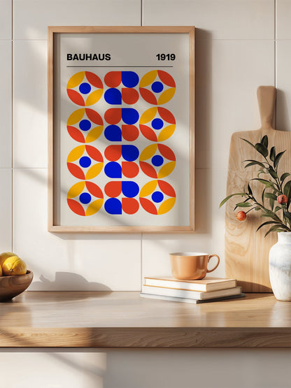 Bauhaus 1919 geometric poster featuring circular medallions in blue red yellow, hanging in contemporary bedroom interior