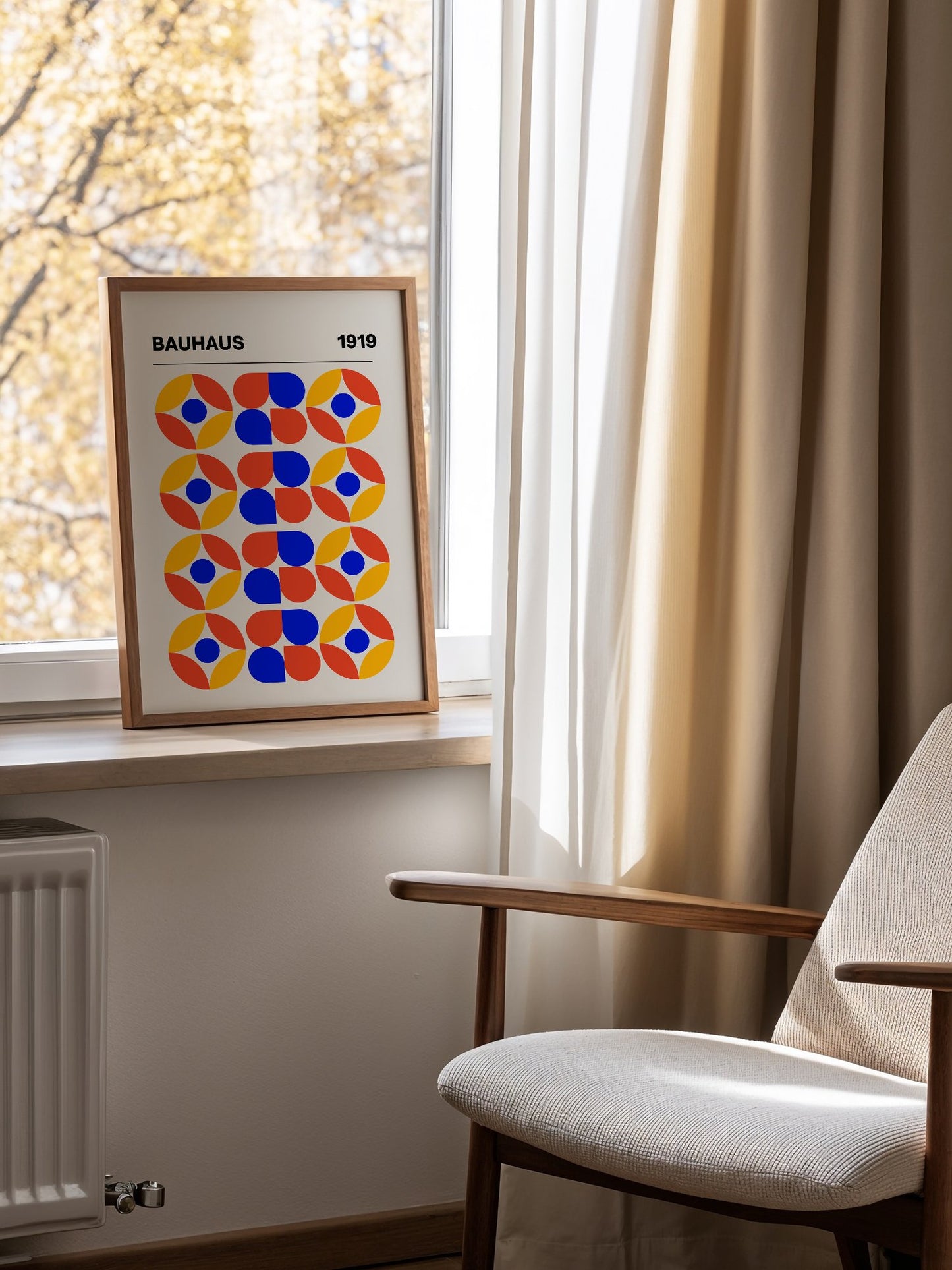 Bauhaus 1919 geometric poster featuring circular medallions in blue red yellow, mounted in bright gallery wall arrangement