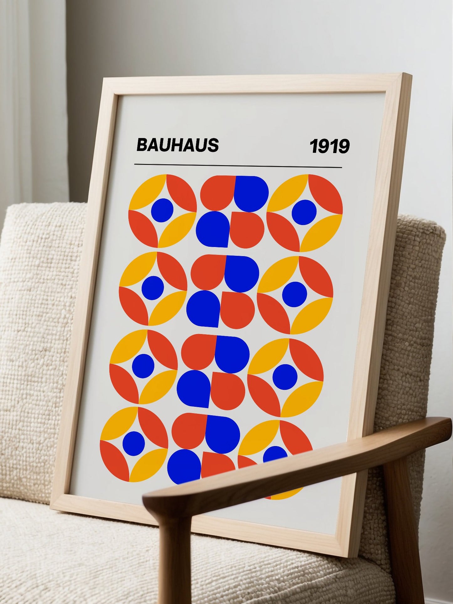 Bauhaus 1919 geometric poster featuring circular medallions in blue red yellow, displayed in modern living room setting