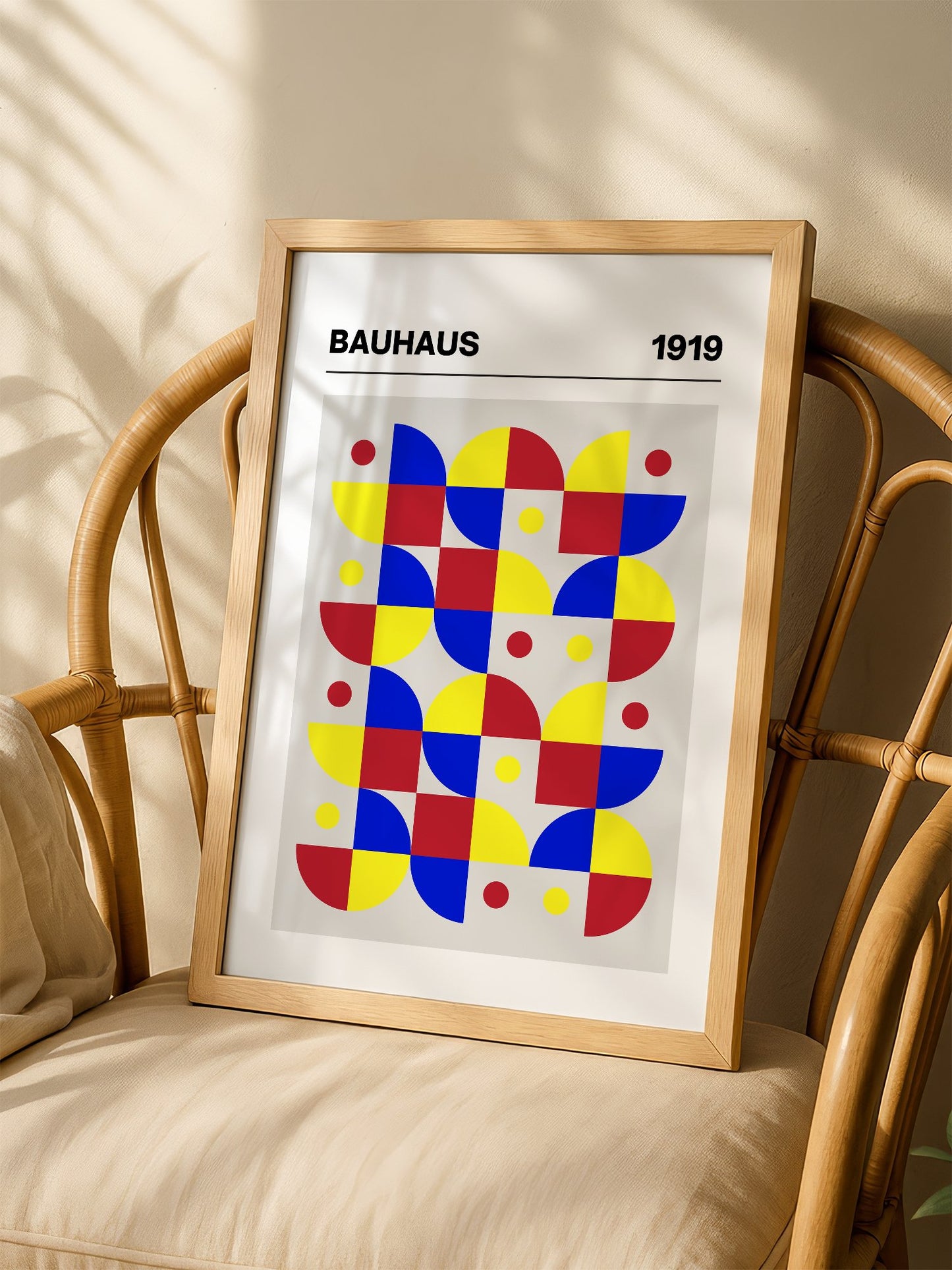 Bauhaus geometric wall art with red blue yellow grid pattern, semicircular, shown in minimalist home office space