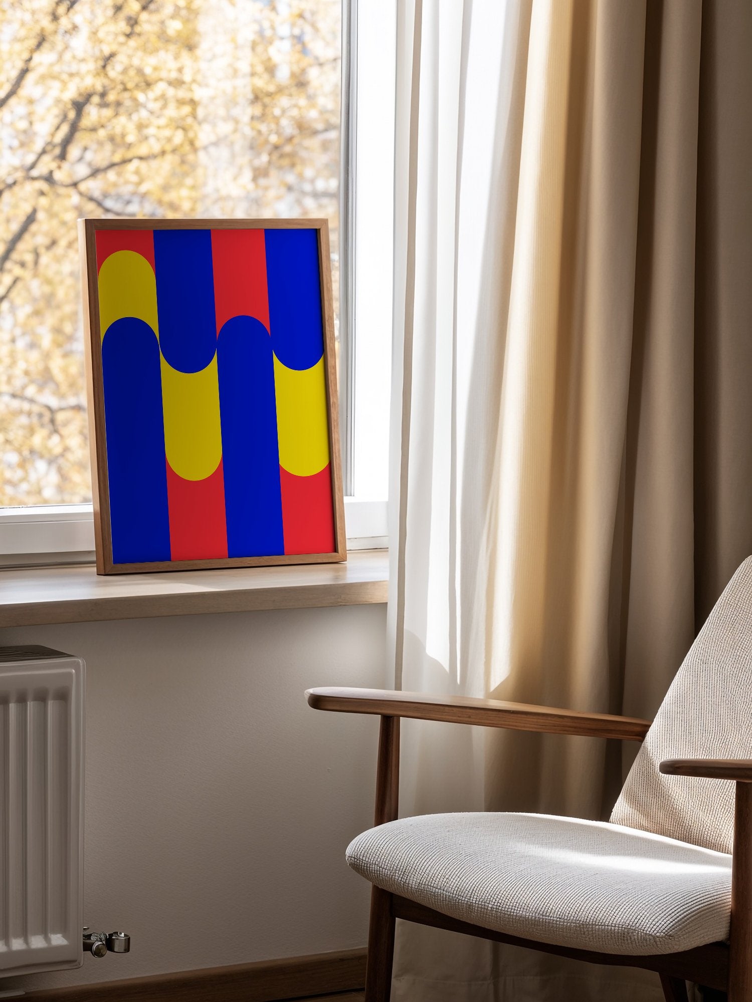 Geometric abstract art print with blue circles on yellow rounded rectangles, mounted in bright gallery wall arrangement