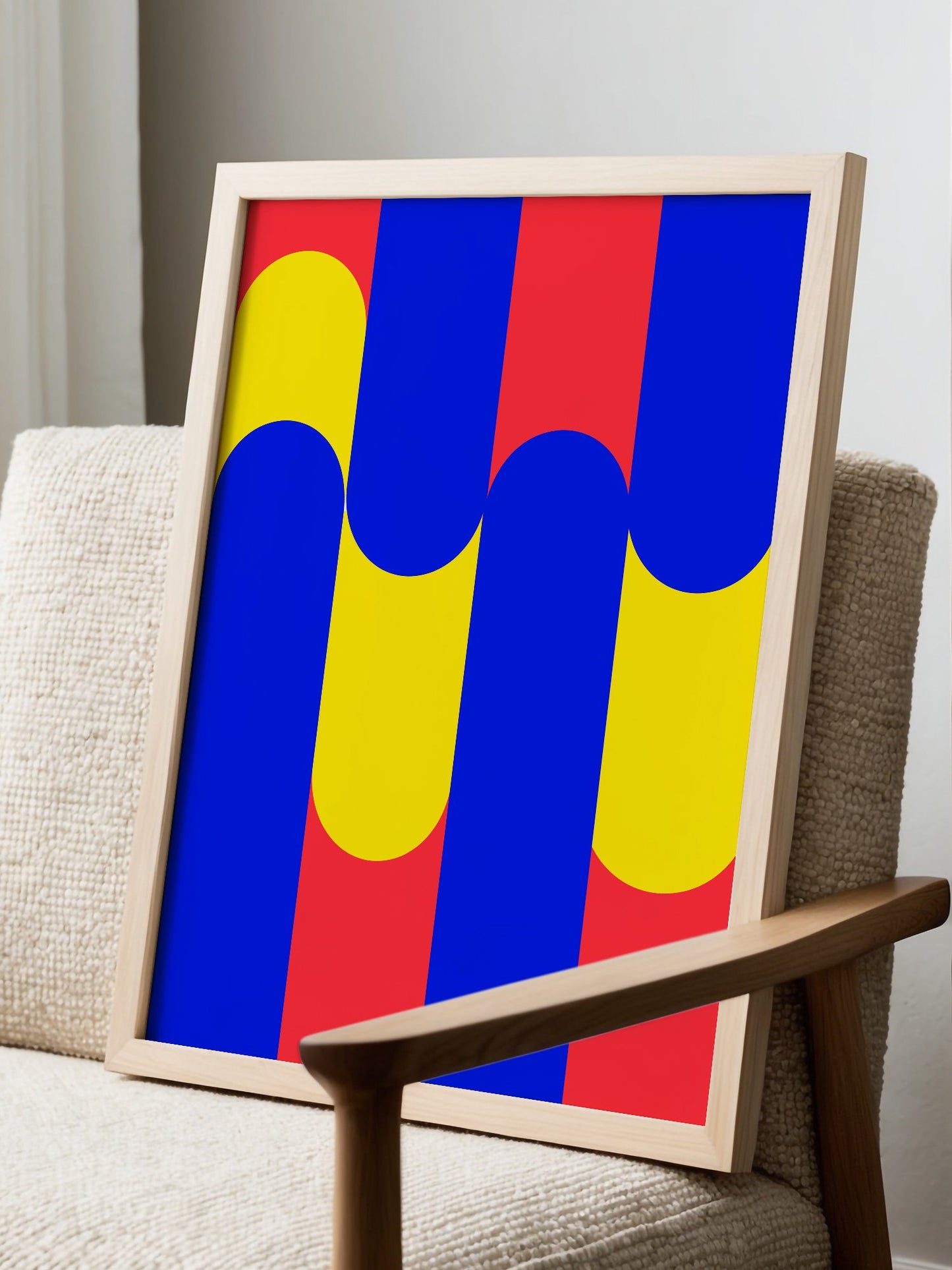Geometric abstract art print with blue circles on yellow rounded rectangles, displayed in modern living room setting