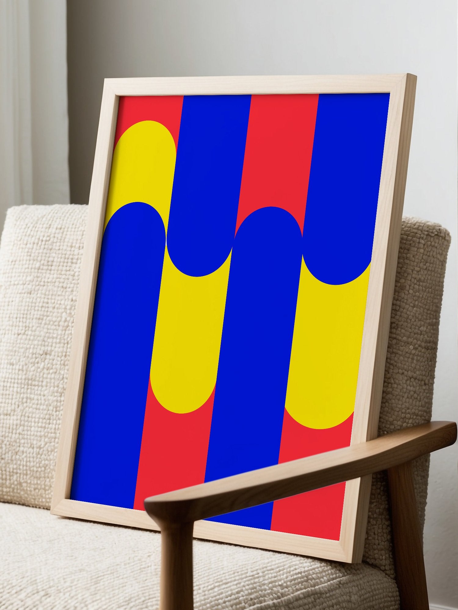 Geometric abstract art print with blue circles on yellow rounded rectangles, displayed in modern living room setting