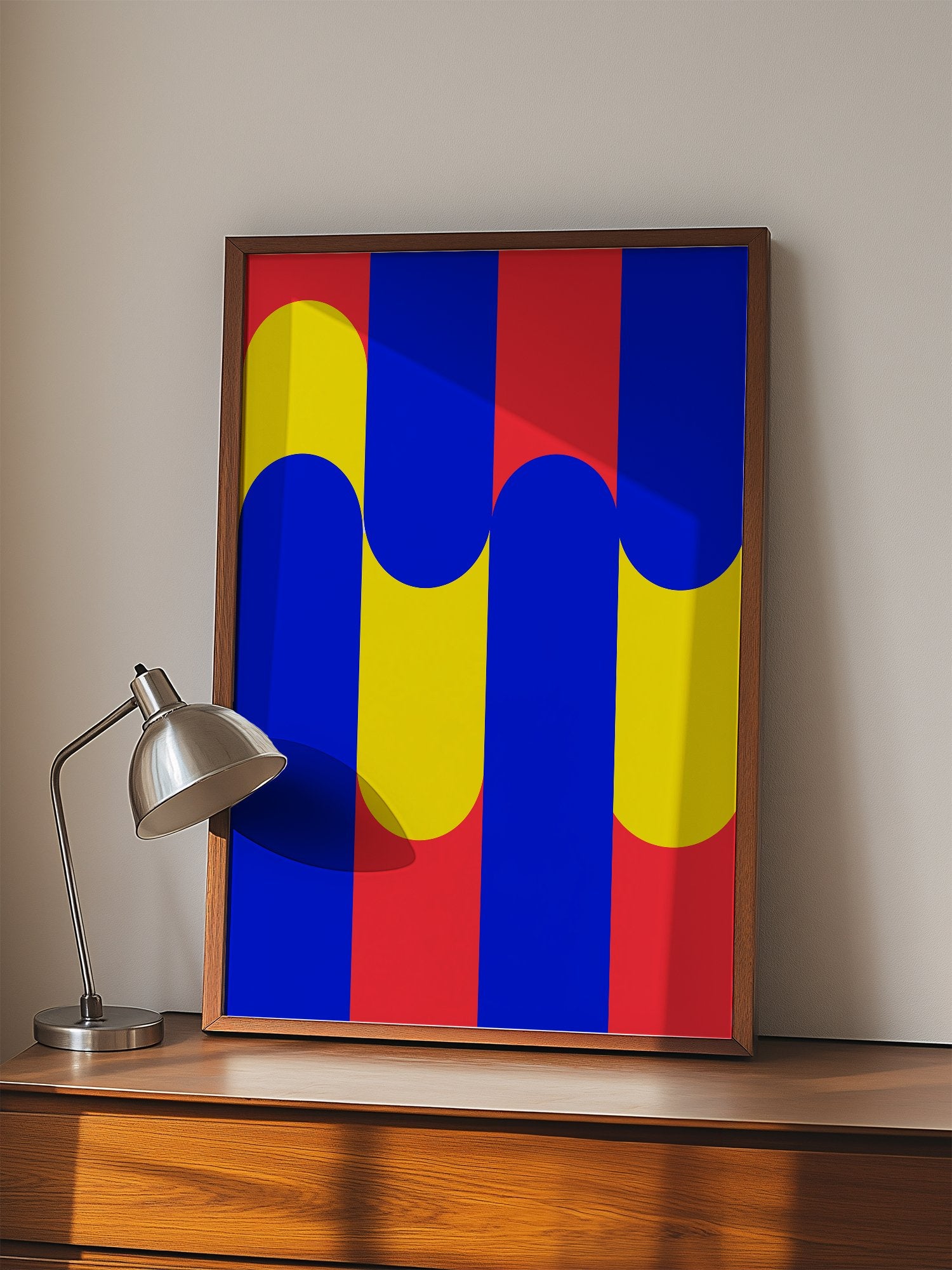 Geometric abstract art print with blue circles on yellow rounded rectangles, displayed in modern living room setting