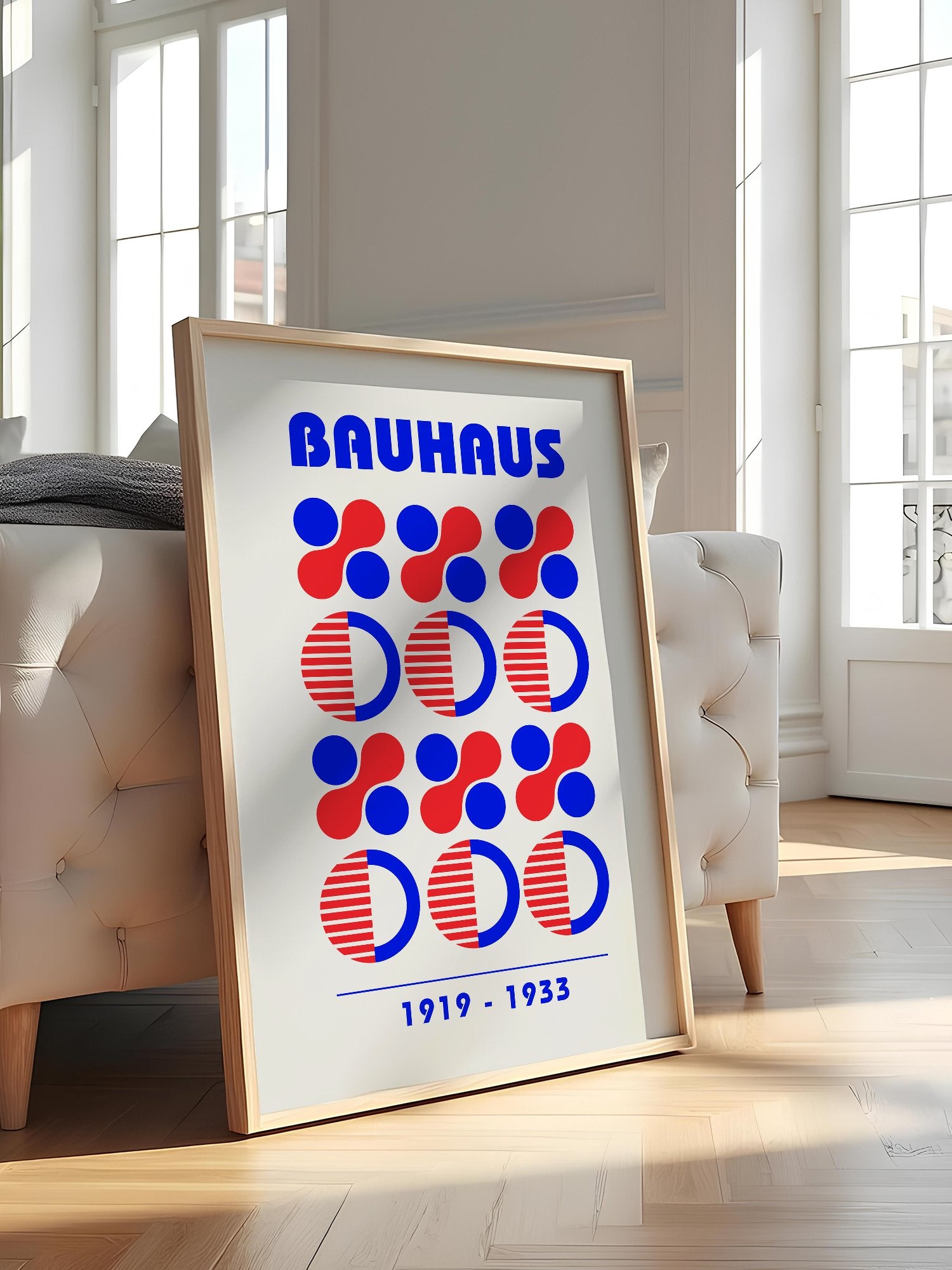 Bauhaus geometric poster featuring blue and red circles and semicircles in grid, featured in stylish apartment decor