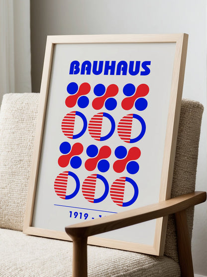 Bauhaus geometric poster featuring blue and red circles and semicircles in grid, displayed in modern living room setting