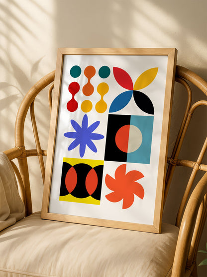 Colourful geometric abstract art print with starbursts, circles and shapes in, shown in minimalist home office space