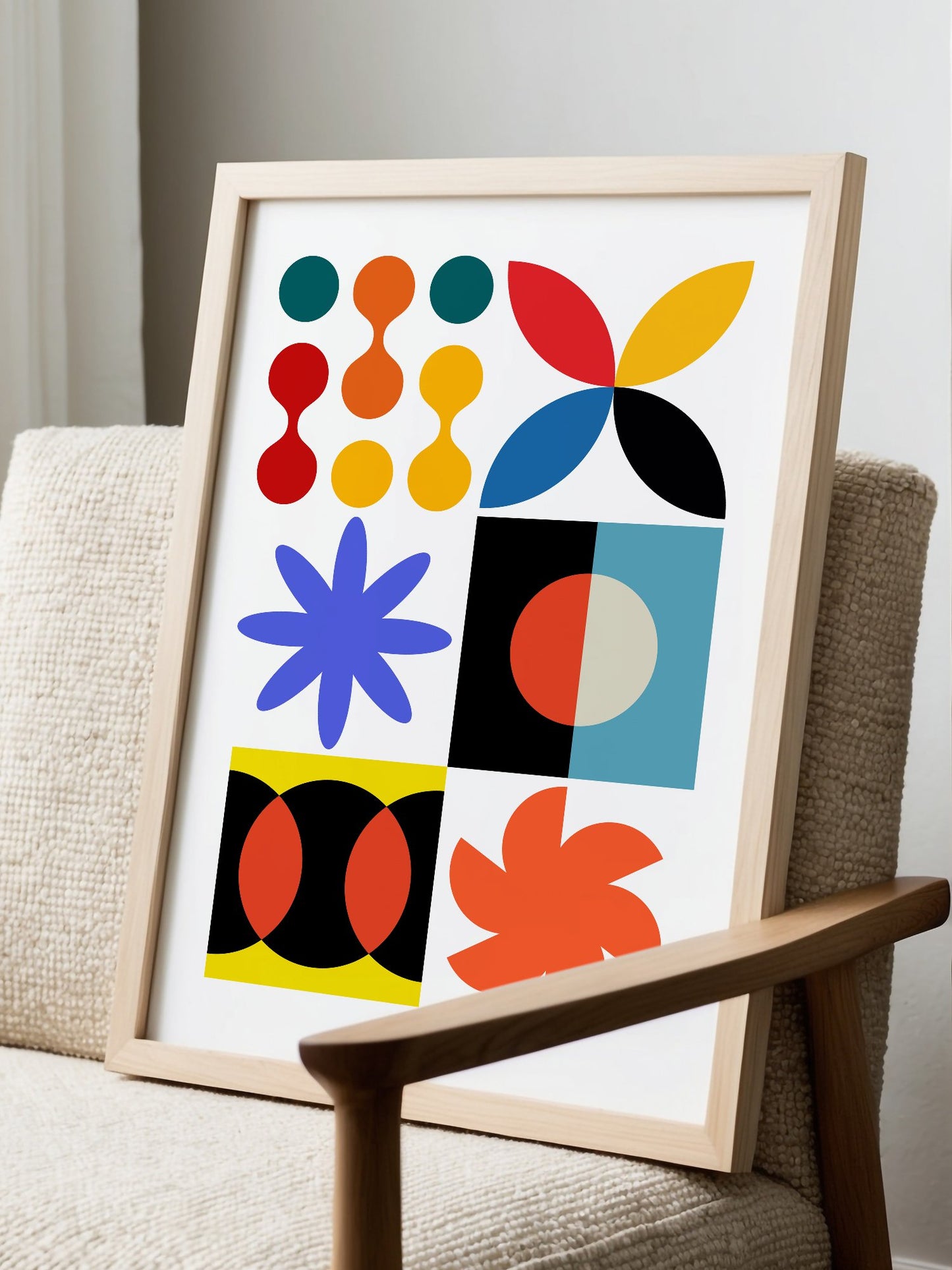 Colourful geometric abstract art print with starbursts, circles and shapes in, displayed in modern living room setting