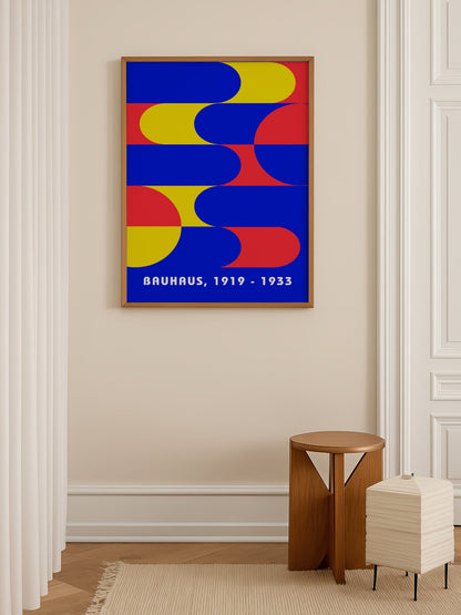 Bauhaus geometric abstract poster with interlocking blue yellow and red shapes, shown in minimalist home office space