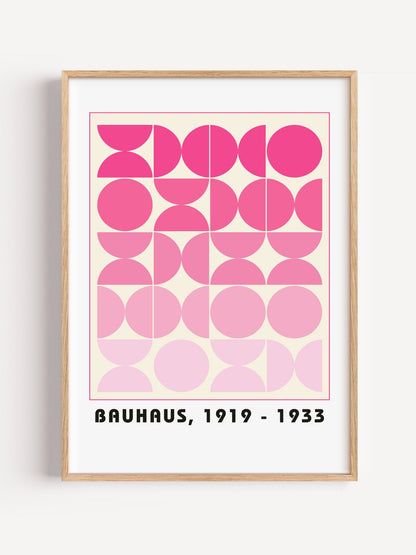 Bauhaus geometric poster featuring pink circles and semicircles in gradient, close-up showing print texture and color detail